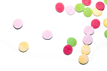 Close up of sugar paper confetti circle spots and colour dots on white background