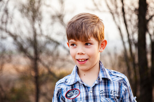 Boy outside in orange light caused by bush fires