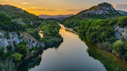 Obraz premium Serene river landscape at sunset with greenery.