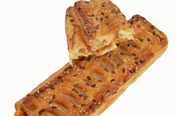A puff pastry bun with filling lies on a white background.