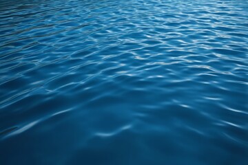 there is a blue water surface with ripples and a boat in the distance