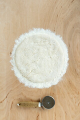 Raw Ball of pizza doug or bread doug on wooden background with copy space, top view