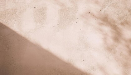 Fototapeta premium soft beige stucco wall with diagonal sunlight shadows and small imperfections, ideal for minimalist background and texture