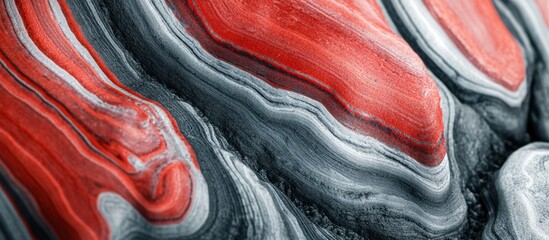 Abstract textured pattern of layered red and black stone with intricate natural formations creating a unique geological background with smooth flowing lines