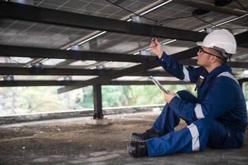 Fototapeta premium Solar panel maintenance engineers are checking the operation of solar panels and circuit boards.