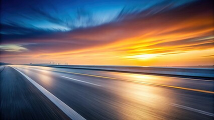 Naklejka premium Asphalt Highway at Sunset, Motion Blur Effect Showing Speed and a Distant Skyline