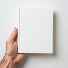 Hand grasping a new plain white notebook for creative work and journaling purposes : Generative AI