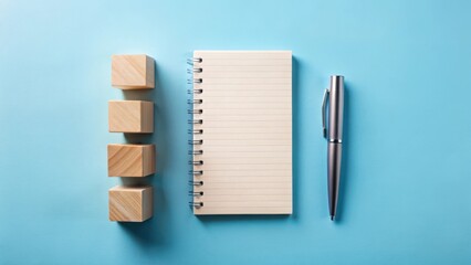Planning Success  Wooden Blocks, Notepad, and Pen on a Light Blue Background