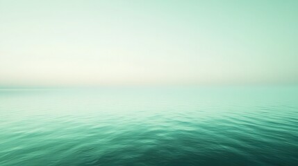 Fototapeta premium Calm teal ocean with light sky creating a peaceful seascape scene