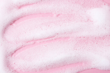 Sample of fluffy foam on pink background, top view