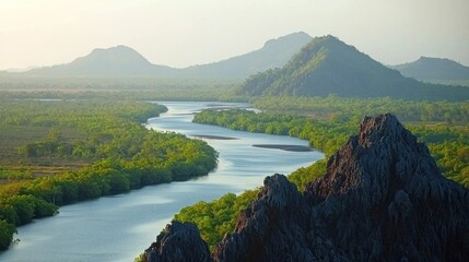 Winding river through lush jungle valley, misty mountains