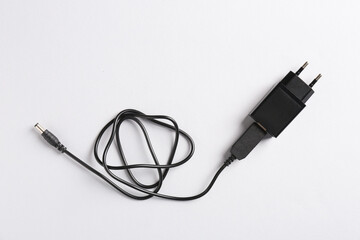 USB power adapter with charge cable on white background, top view
