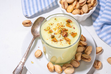 Vegan alternative non-dairy pistachio heavy cream, pistachio pudding or yogurt, with crushed pistachio nuts, copy space