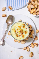 Vegan alternative non-dairy pistachio heavy cream, pistachio pudding or yogurt, with crushed pistachio nuts, copy space