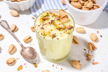 Vegan alternative non-dairy pistachio heavy cream, pistachio pudding or yogurt, with crushed pistachio nuts, copy space