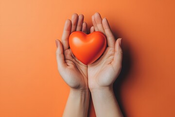 Warm hands cradle a vibrant orange heart symbolizing love and care in a cozy, inviting atmosphere