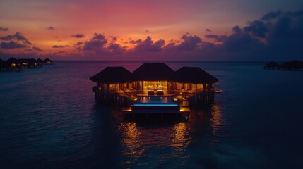 Luxury overwater resort at twilight with infinity pool and sunset view