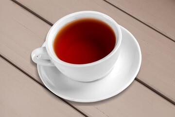 Tasty hot tea in cup on desk top for breakfast