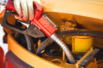 Fueling equipment at construction site  with worker handling gas pump