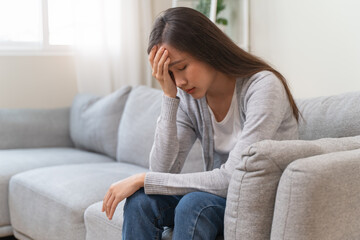 Young Asian females feeling dizzy after standing too fast, have symptoms of low blood pressure