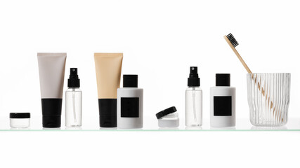 Different cosmetic products on a glass shelf on white background. Mockup of skincare and bath products on a glass shelf
