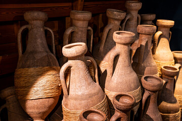 Ancient Etruscan Amphorae with Rope Wrapping in Rustic Museum Display