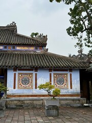 Traditional blue temple wall with intricate details in Hue, Vietnam