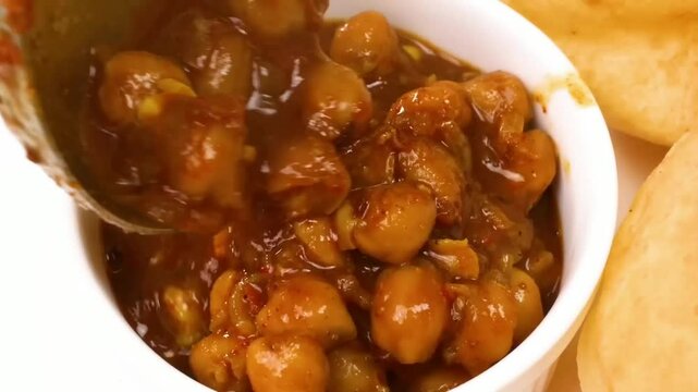 Chole Bhature &ndash; A famous North Indian street food with spicy chickpea curry (Chole) and crispy deep-fried bread (Bhature). Indians favorite, loved in restaurants, homes, and street food stalls.