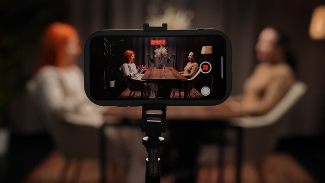 Two Influencers of women being interviewed in a loft-style podcast studio