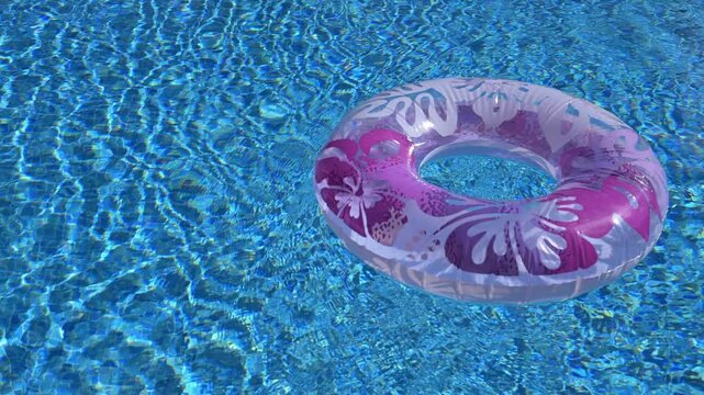 Pink Inflatable ring floating in a swimming pool