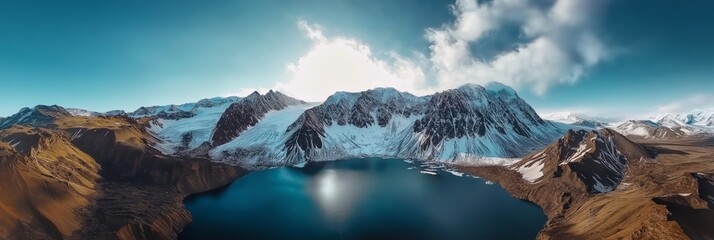 Panoramic landscape showcases snow-capped peaks and deep blue glacier lakes at sunrise with a bird's eye view over the horizon captured in stunning clarity