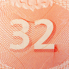 Close-up of intricate orange number 32 design on white background.