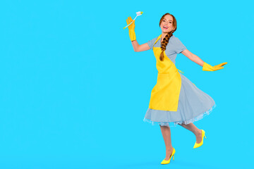Brightly dressed woman joyfully cleaning with paintbrush in hand against a vibrant blue background