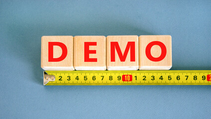 Demo symbol. Concept word Demo on beautiful wooden blocks. Beautiful yellow ruler. Beautiful blue...