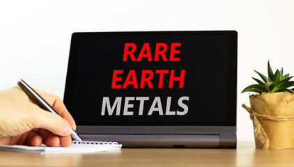 Rare earth metals symbol. Concept words Rare earth metals on beautiful black tablet. Businessman...