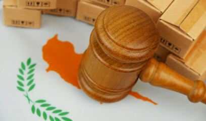 Import and tariffs rules of Cyprus concept. Judge gavel, Cypriot flag and many carton boxes.