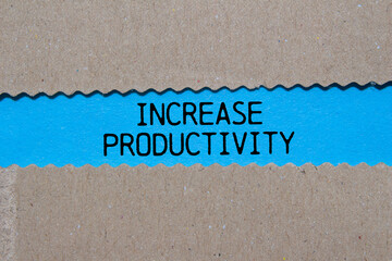 Increase productivity message written on ripped torn paper on blue background. Conceptual increase...