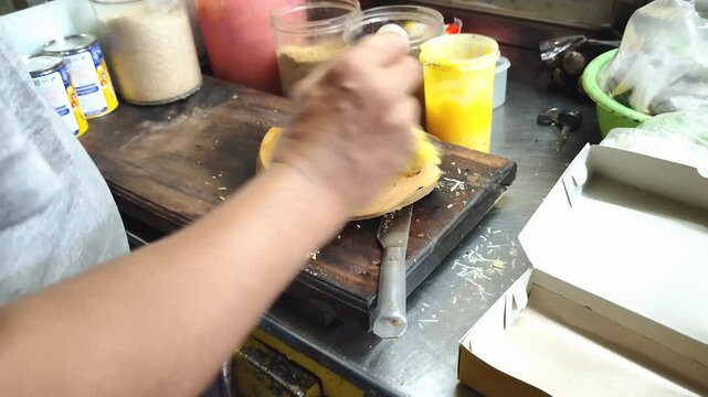 Male chef prepares terang bulan bread or sweet martabak