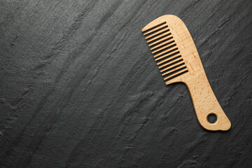 One wooden hair comb on grey background, top view. Space for text
