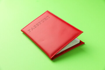 Passport in red cover on green background, closeup