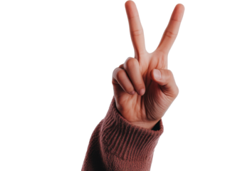 Hand making peace sign gesture on white background during daylight showcasing positivity and optimism