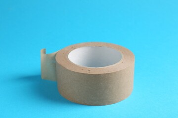 Roll of masking tape on light blue background