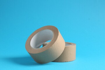 Rolls of masking tapes on light blue background