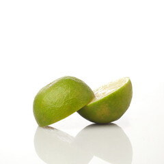 Isolated in White Background, Fresh Green Lime Halved With a Vibrant Interior Showcasing Juicy Segments and Smooth Texture