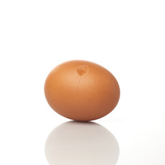 Isolated in White Background, a Brown Egg With a Small Crack Shows Signs of Breaking or Hatching