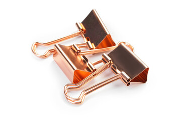 Two golden binder clips isolated on white