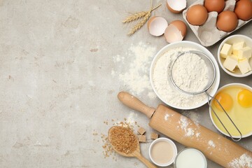 Rolling pin and different ingredients on light table, flat lay. Space for text