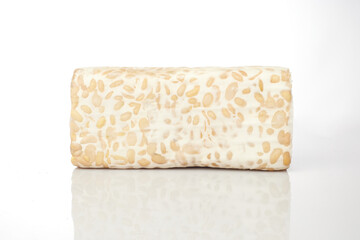 Isolated in White Background, Rectangular Block of Tempeh Showcasing Texture and Natural Color Variations