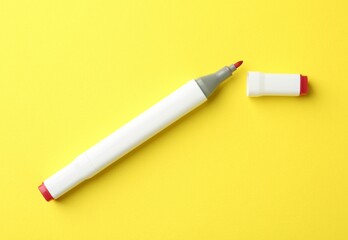 One color double sided marker on yellow background, top view
