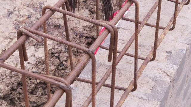 Construction workers using reinforced tmt steel bar with ease at the construction site, Reinforced bar (rebar). TMT steel rods tied together forming the core of concrete